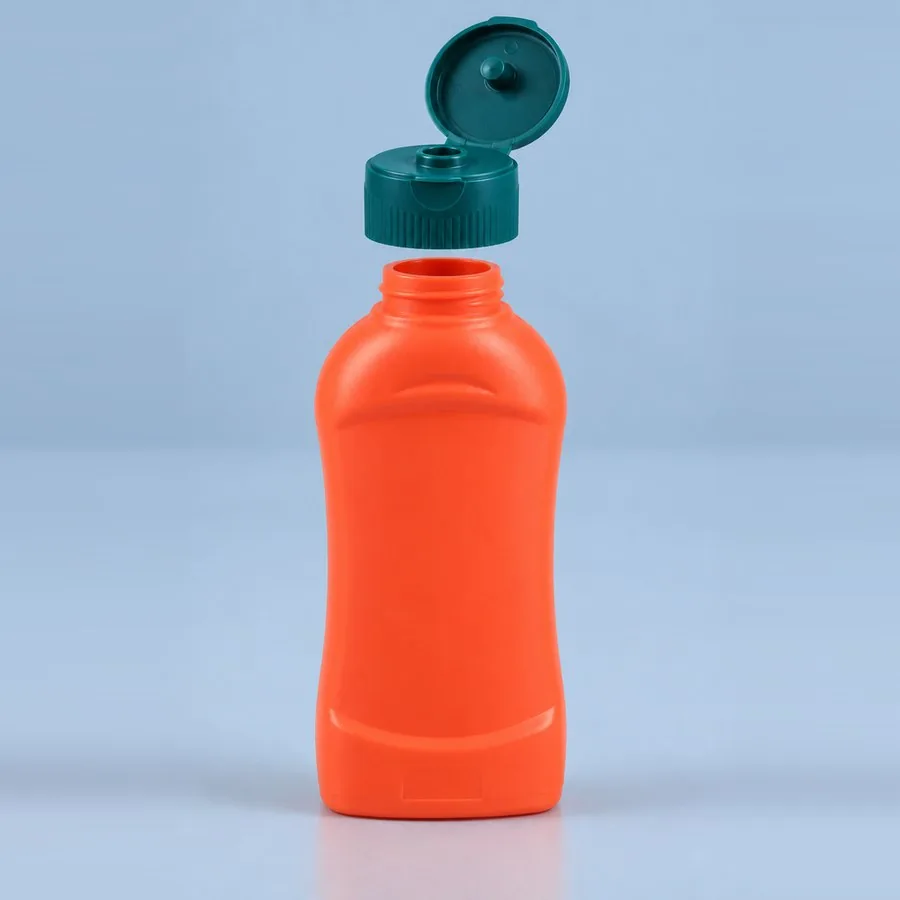 Orange-red 600 g plastic Chilli Ketchup squeeze bottle with green flip-top cap open, by Majid Industries