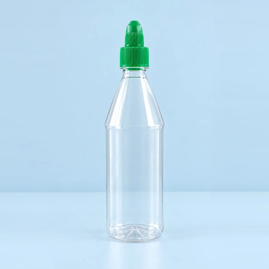 Clear 500 g PET ketchup bottle with green twist-open nozzle cap, by Majid Industries