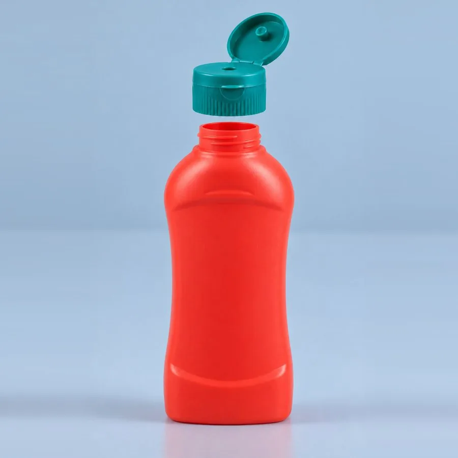 Red 600 g plastic Ketchup squeeze bottle with green flip-top cap open, by Majid Industries